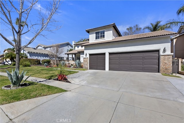 11934 Timber Mountain Ct, Rancho Cucamonga, CA 91739 - view of front facade with driveway, brick siding, a front lawn, stucco siding, and a garage