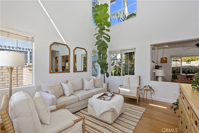 11934 Timber Mountain Ct, Rancho Cucamonga, CA 91739 - living area featuring wood finished floors, baseboards, and a towering ceiling