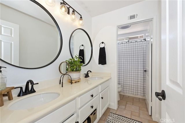 11934 Timber Mountain Ct, Rancho Cucamonga, CA 91739 - bathroom featuring toilet, double vanity, stone finish floors, and a shower with shower curtain