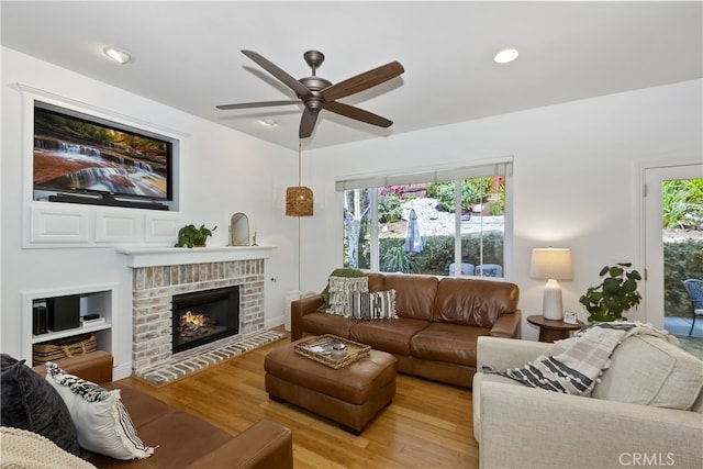 11934 Timber Mountain Ct, Rancho Cucamonga, CA 91739 - living room featuring ceiling fan, light wood finished floors, a fireplace, and recessed lighting
