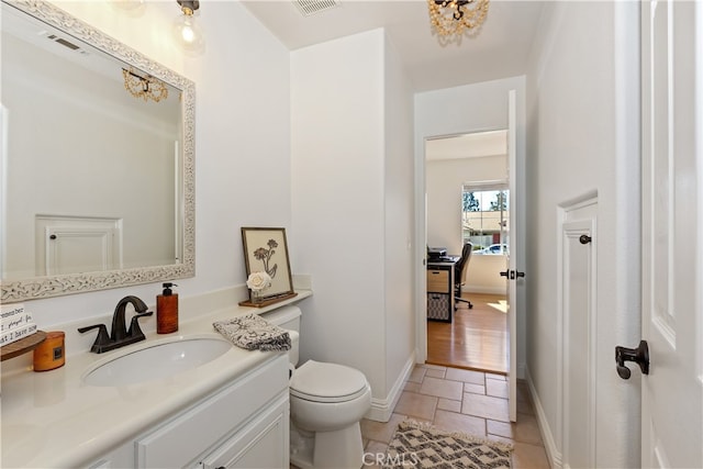11934 Timber Mountain Ct, Rancho Cucamonga, CA 91739 - bathroom featuring toilet, vanity, baseboards, and stone tile floors