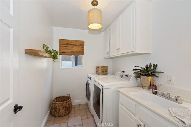 11934 Timber Mountain Ct, Rancho Cucamonga, CA 91739 - washroom featuring cabinet space, baseboards, washer and dryer, and light stone finish flooring