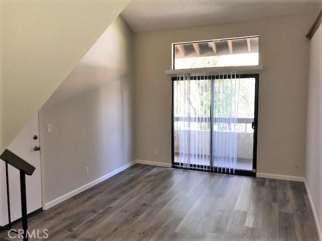 empty room with wood finished floors and baseboards