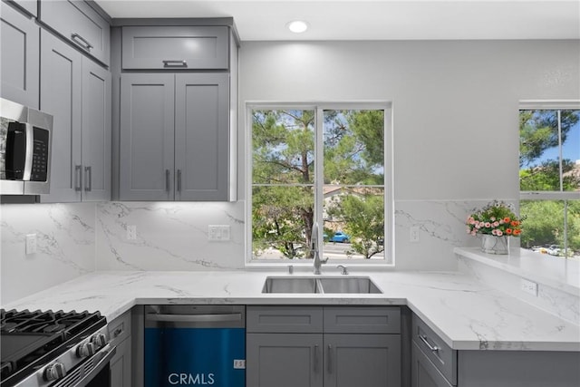 17979 Lost Canyon Rd Unit 104, Canyon Country, CA 91387 - kitchen with appliances with stainless steel finishes, gray cabinetry, a sink, tasteful backsplash, and recessed lighting