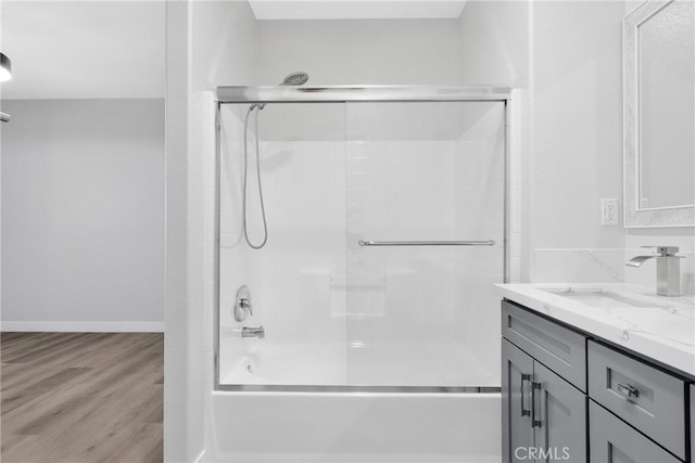 17979 Lost Canyon Rd Unit 104, Canyon Country, CA 91387 - full bathroom with wood finished floors, bath / shower combo with glass door, and vanity