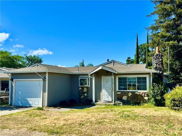 single story home with a garage, stucco siding, a front yard, stone siding, and concrete driveway