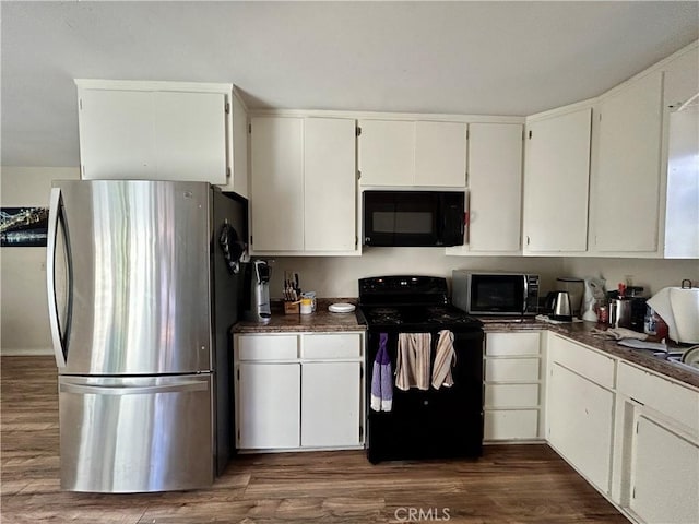 kitchen with black appliances, dark countertops, dark wood finished floors, and white cabinets