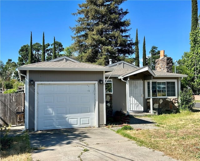ranch-style home featuring driveway, a chimney, a garage, and fence