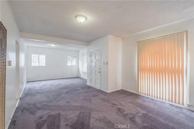 144 W 101st St, Los Angeles, CA 90003 - spare room featuring carpet flooring, a textured ceiling, and baseboards