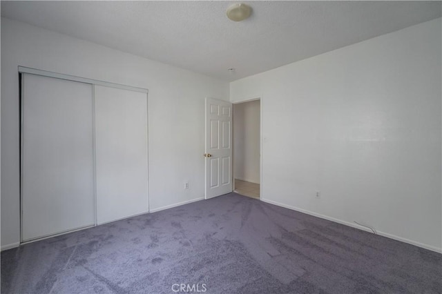 144 W 101st St, Los Angeles, CA 90003 - unfurnished bedroom with carpet flooring, a closet, and baseboards