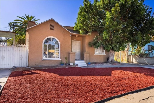 144 W 101st St, Los Angeles, CA 90003 - view of front facade with fence and stucco siding