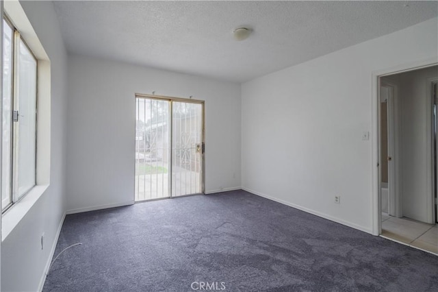 144 W 101st St, Los Angeles, CA 90003 - carpeted empty room with a textured ceiling and baseboards