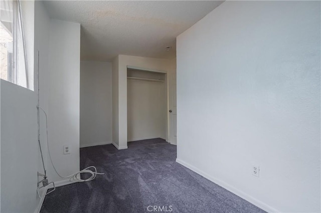 144 W 101st St, Los Angeles, CA 90003 - unfurnished bedroom with carpet flooring, baseboards, a closet, and a textured ceiling