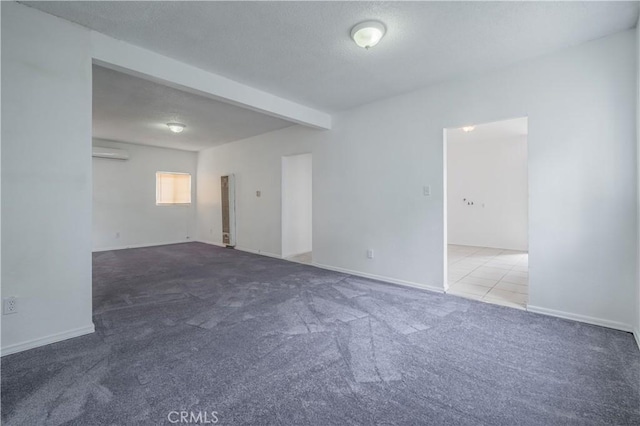 144 W 101st St, Los Angeles, CA 90003 - empty room with carpet, baseboards, beam ceiling, and a wall mounted air conditioner