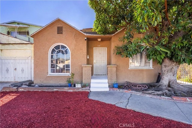144 W 101st St, Los Angeles, CA 90003 - view of front of property featuring stucco siding and fence