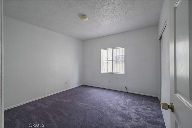 144 W 101st St, Los Angeles, CA 90003 - unfurnished room with dark colored carpet, a textured ceiling, and baseboards