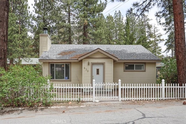433 Conklin Rd, Big Bear Lake, CA 92315 - view of front of house featuring a shingled roof, a fenced front yard, and a chimney