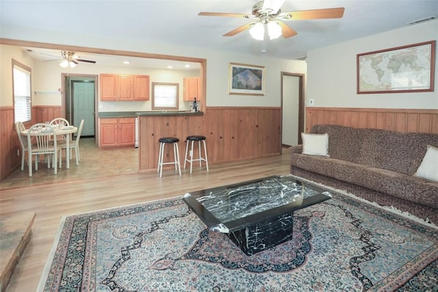 433 Conklin Rd, Big Bear Lake, CA 92315 - living room with a wainscoted wall, a ceiling fan, wood walls, and light wood-style floors
