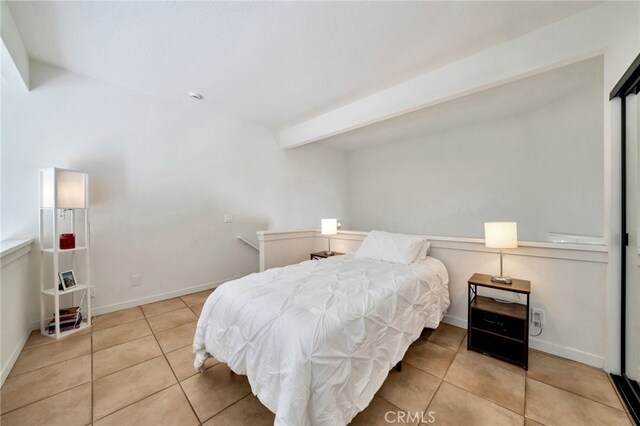 5145 Tortuga Dr Unit 209, Huntington Beach, CA 92649 - bedroom with tile patterned floors and beamed ceiling