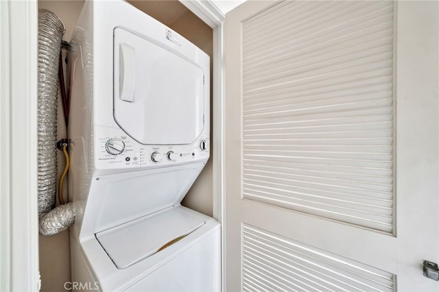 5145 Tortuga Dr Unit 209, Huntington Beach, CA 92649 - laundry room featuring stacked washing machine and dryer