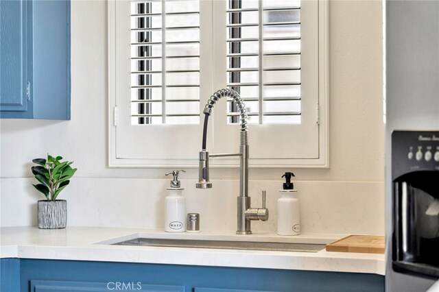 5145 Tortuga Dr Unit 209, Huntington Beach, CA 92649 - kitchen view of blue cabinetry and light countertops