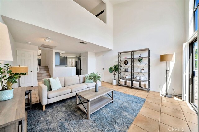 5145 Tortuga Dr Unit 209, Huntington Beach, CA 92649 - living area with tile patterned floors and a high ceiling
