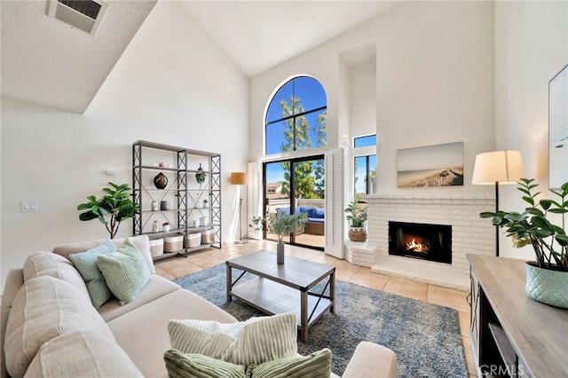 5145 Tortuga Dr Unit 209, Huntington Beach, CA 92649 - living area with light tile patterned floors, high vaulted ceiling, and a fireplace