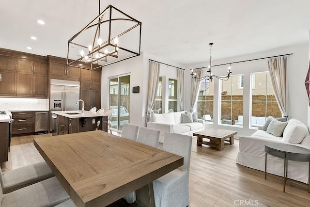 20702 W Chestnut Cir, Porter Ranch, CA 91326 - dining space featuring a chandelier, light wood-type flooring, healthy amount of natural light, and recessed lighting
