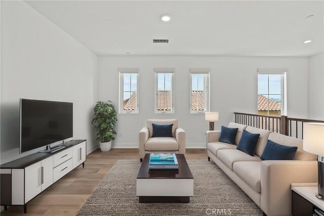 20702 W Chestnut Cir, Porter Ranch, CA 91326 - living room featuring healthy amount of natural light, light wood finished floors, baseboards, and recessed lighting