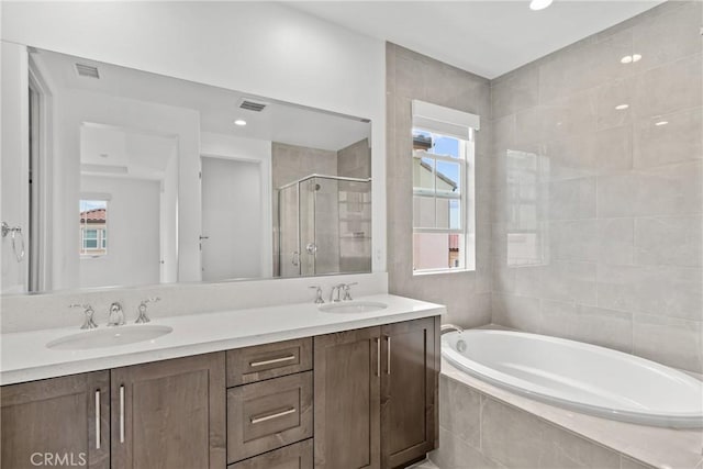 20702 W Chestnut Cir, Porter Ranch, CA 91326 - full bathroom with a shower stall, a bath, healthy amount of natural light, double vanity, and recessed lighting