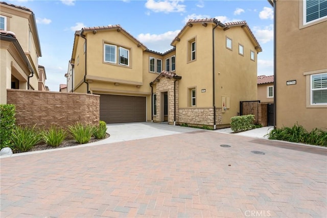 20702 W Chestnut Cir, Porter Ranch, CA 91326 - mediterranean / spanish house featuring an attached garage, stucco siding, fence, decorative driveway, and a tiled roof