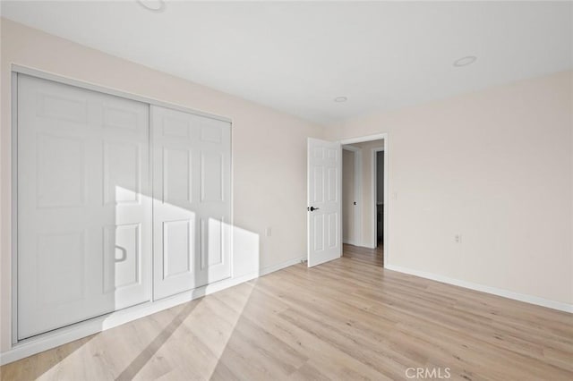 2134 Via Puerta Unit O, Laguna Woods, CA 92637 - unfurnished bedroom with light wood-style flooring, baseboards, and a closet