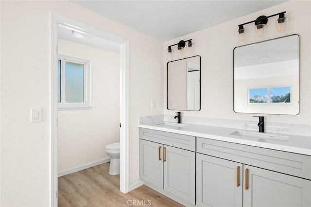 2134 Via Puerta Unit O, Laguna Woods, CA 92637 - full bath featuring wood finished floors, toilet, double vanity, and baseboards