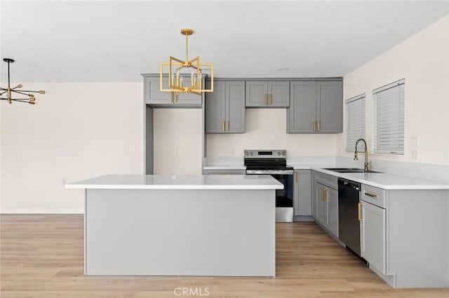 2134 Via Puerta Unit O, Laguna Woods, CA 92637 - kitchen with stainless steel electric stove, black dishwasher, gray cabinets, a sink, and a chandelier