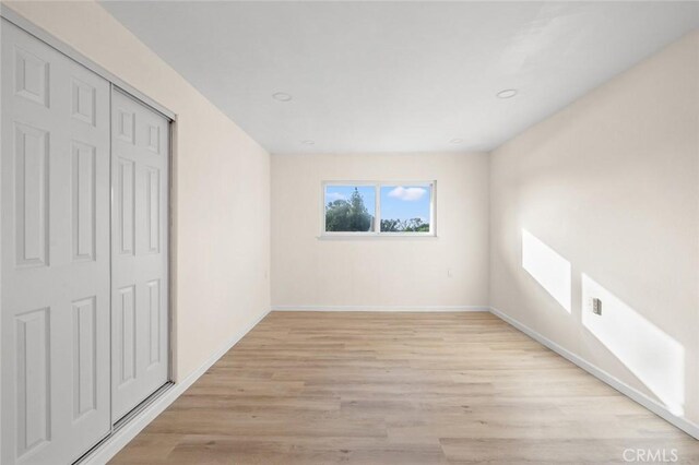 2134 Via Puerta Unit O, Laguna Woods, CA 92637 - unfurnished bedroom featuring light wood finished floors, baseboards, a closet, and recessed lighting