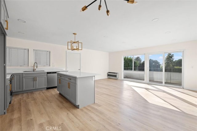 2134 Via Puerta Unit O, Laguna Woods, CA 92637 - kitchen featuring gray cabinets, a sink, stainless steel dishwasher, light wood-style floors, and light countertops