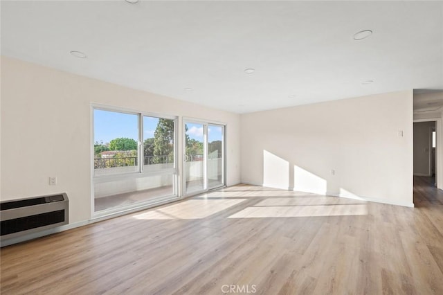 2134 Via Puerta Unit O, Laguna Woods, CA 92637 - unfurnished living room with light wood-style floors and heating unit