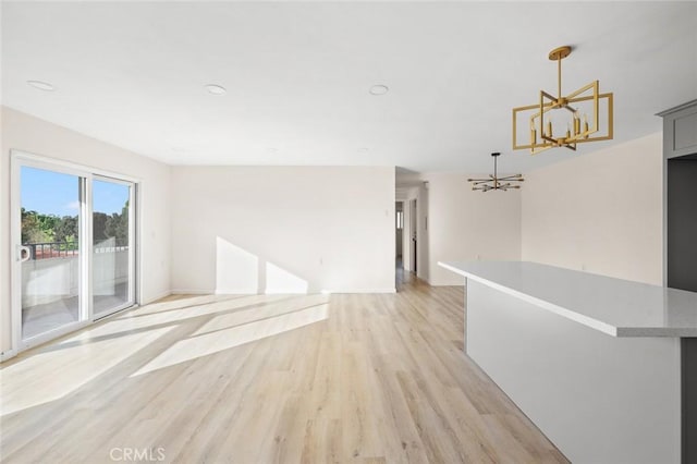 2134 Via Puerta Unit O, Laguna Woods, CA 92637 - unfurnished room featuring a chandelier, light wood finished floors, and baseboards