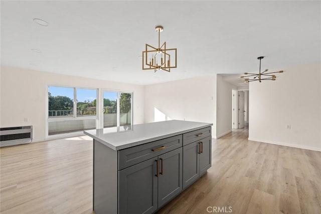 2134 Via Puerta Unit O, Laguna Woods, CA 92637 - kitchen with a chandelier, gray cabinets, light wood-type flooring, and open floor plan