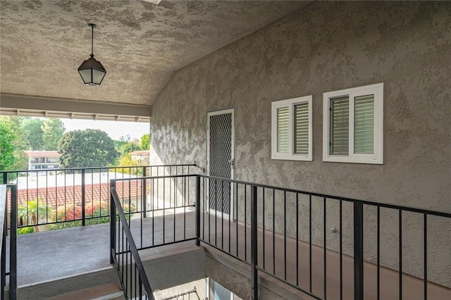 2134 Via Puerta Unit O, Laguna Woods, CA 92637 - view of exterior entry featuring stucco siding and a balcony