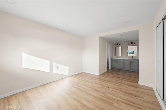 2134 Via Puerta Unit O, Laguna Woods, CA 92637 - unfurnished living room with light wood-style flooring and baseboards
