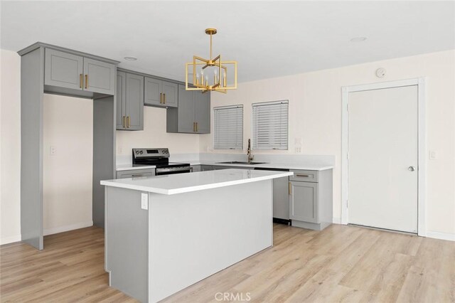 2134 Via Puerta Unit O, Laguna Woods, CA 92637 - kitchen with appliances with stainless steel finishes, gray cabinetry, a sink, and a chandelier
