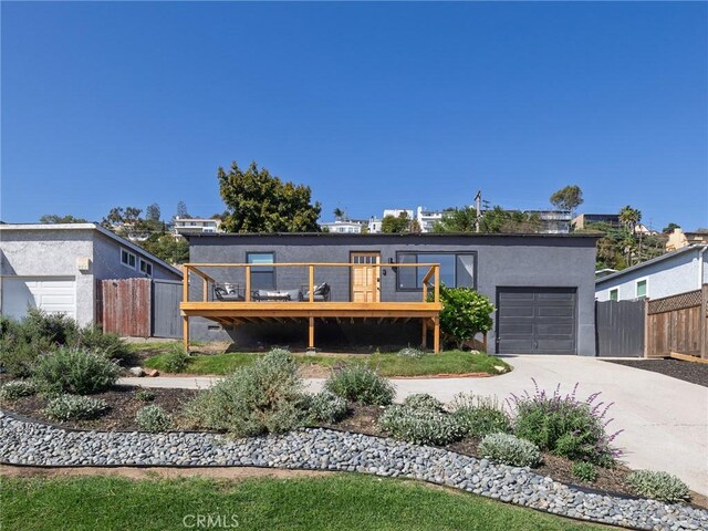 4068 Newton, Torrance, CA 90505 - modern home featuring a wooden deck, an attached garage, concrete driveway, and stucco siding