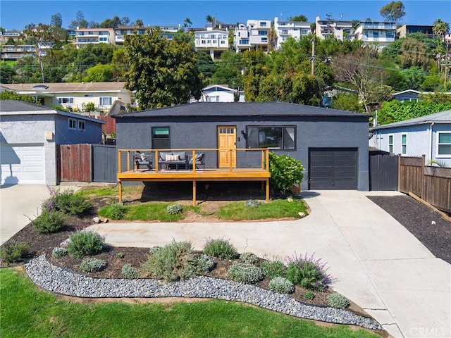 4068 Newton, Torrance, CA 90505 - view of front of home featuring concrete driveway, stucco siding, a deck, and an attached garage