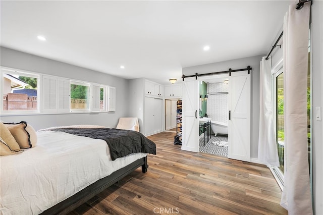 8204 Clemens Ave, West Hills, CA 91304 - bedroom with a barn door, wood finished floors, and recessed lighting