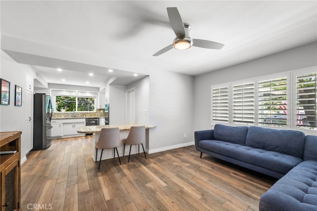 8204 Clemens Ave, West Hills, CA 91304 - living room with wood finished floors, recessed lighting, and a ceiling fan