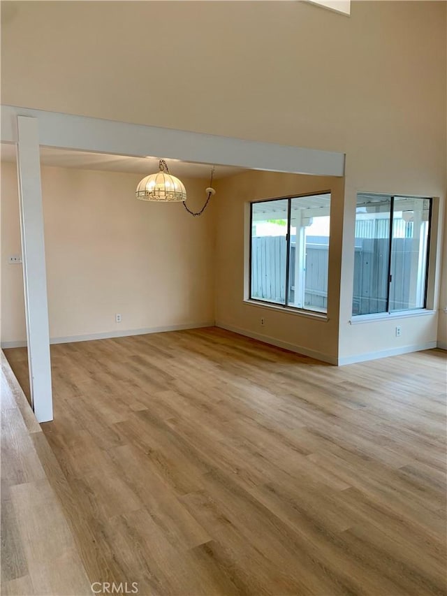8818 Keremeos Way, San Diego, CA 92126 - unfurnished room with light wood-type flooring, a chandelier, and baseboards