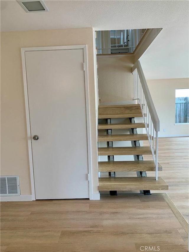 8818 Keremeos Way, San Diego, CA 92126 - staircase with wood finished floors