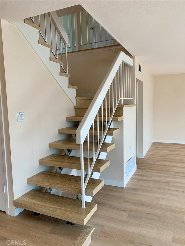8818 Keremeos Way, San Diego, CA 92126 - staircase with wood finished floors and baseboards