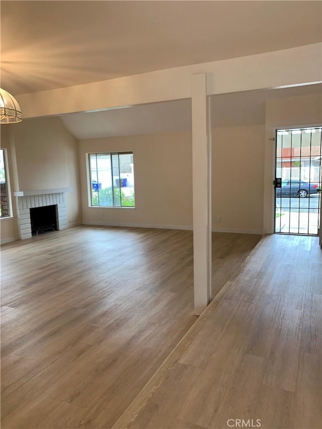 8818 Keremeos Way, San Diego, CA 92126 - unfurnished living room with light wood finished floors, a fireplace, and vaulted ceiling